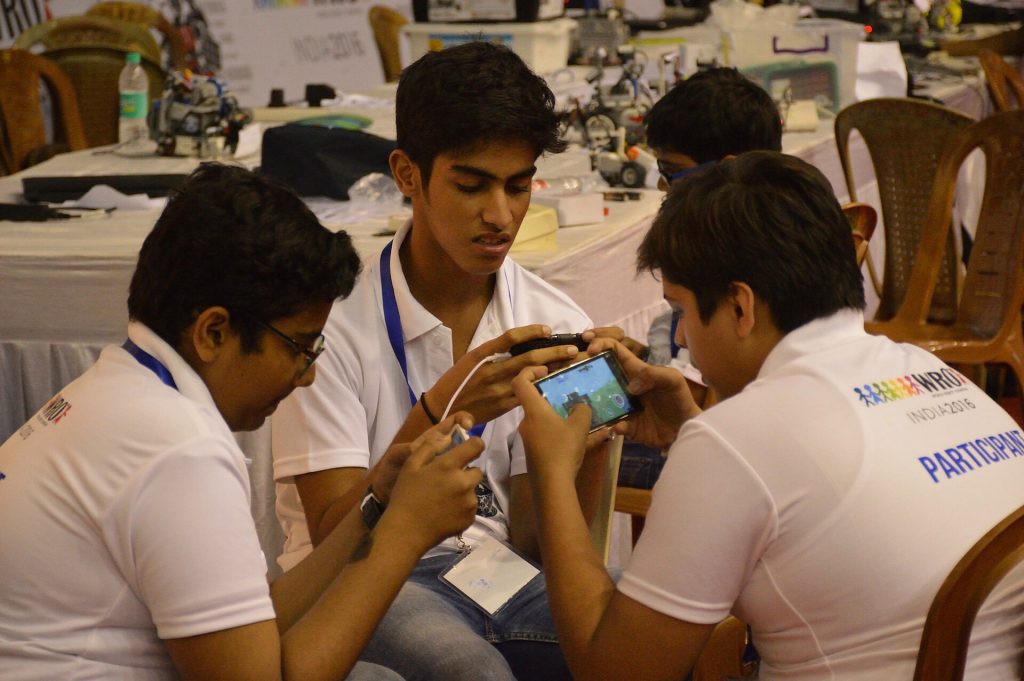 Discover the Exciting World of Free Online Games Students playing a mobile game together on a smartphone